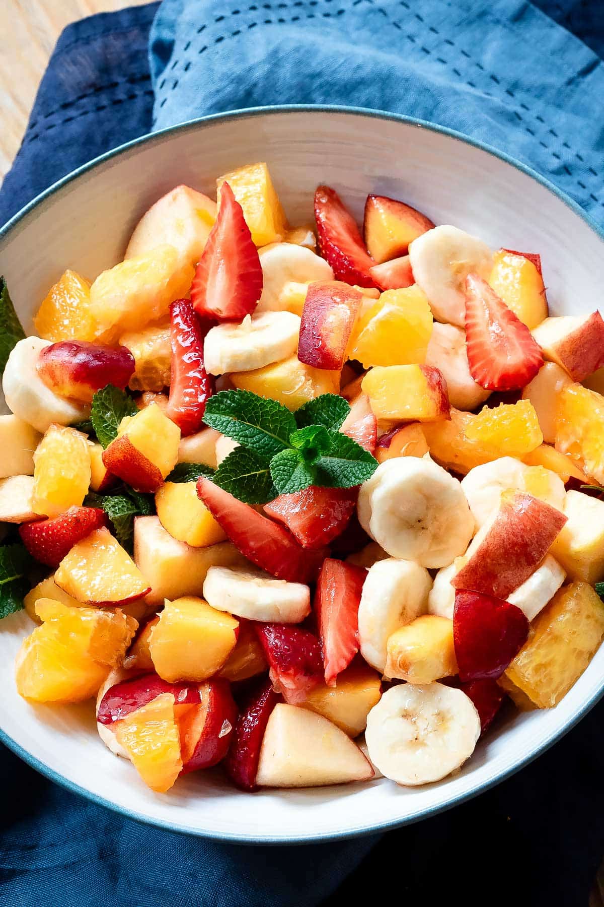 Italian fruit salad in a bowl with a blue lining.