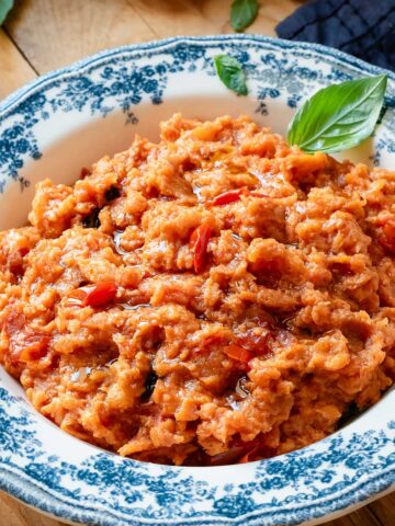 Pappa Al Pomodoro soup in a bowl garnished with a basil leaf.