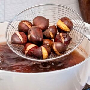 Boiled chestnuts in a sieve.