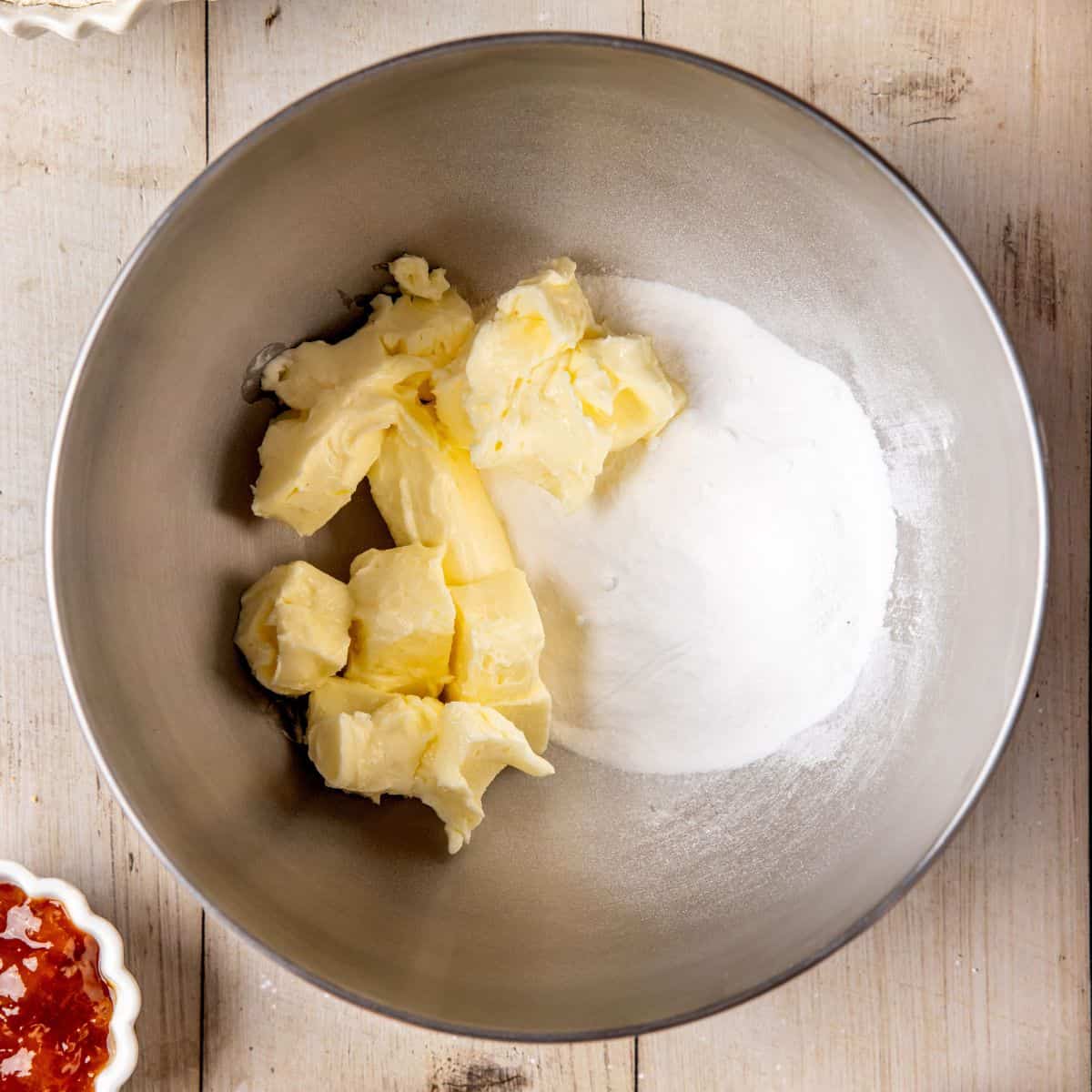 Powdered sugar with softened butter in a mixer bowl.