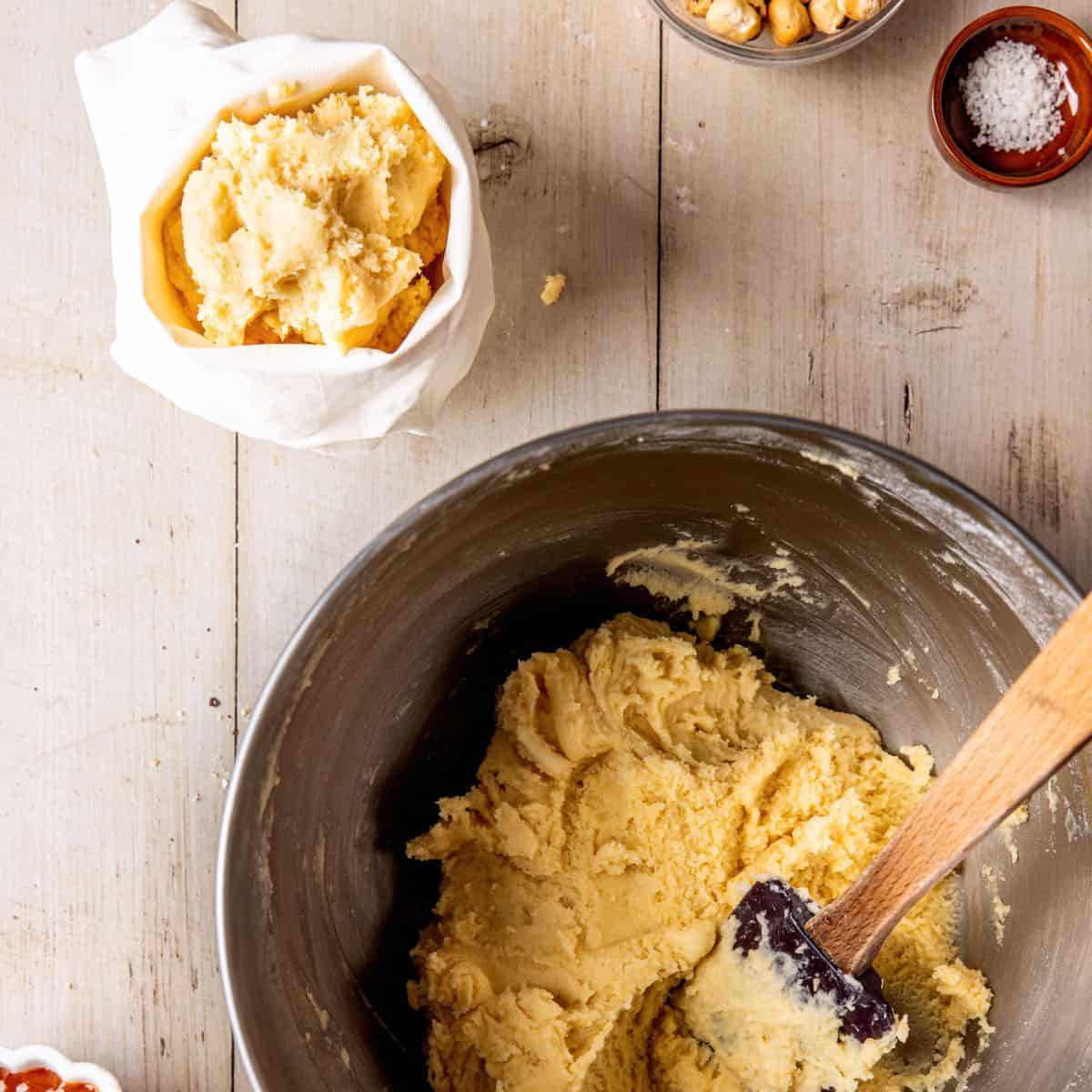 Arranging cookie batter in a pastry bag.