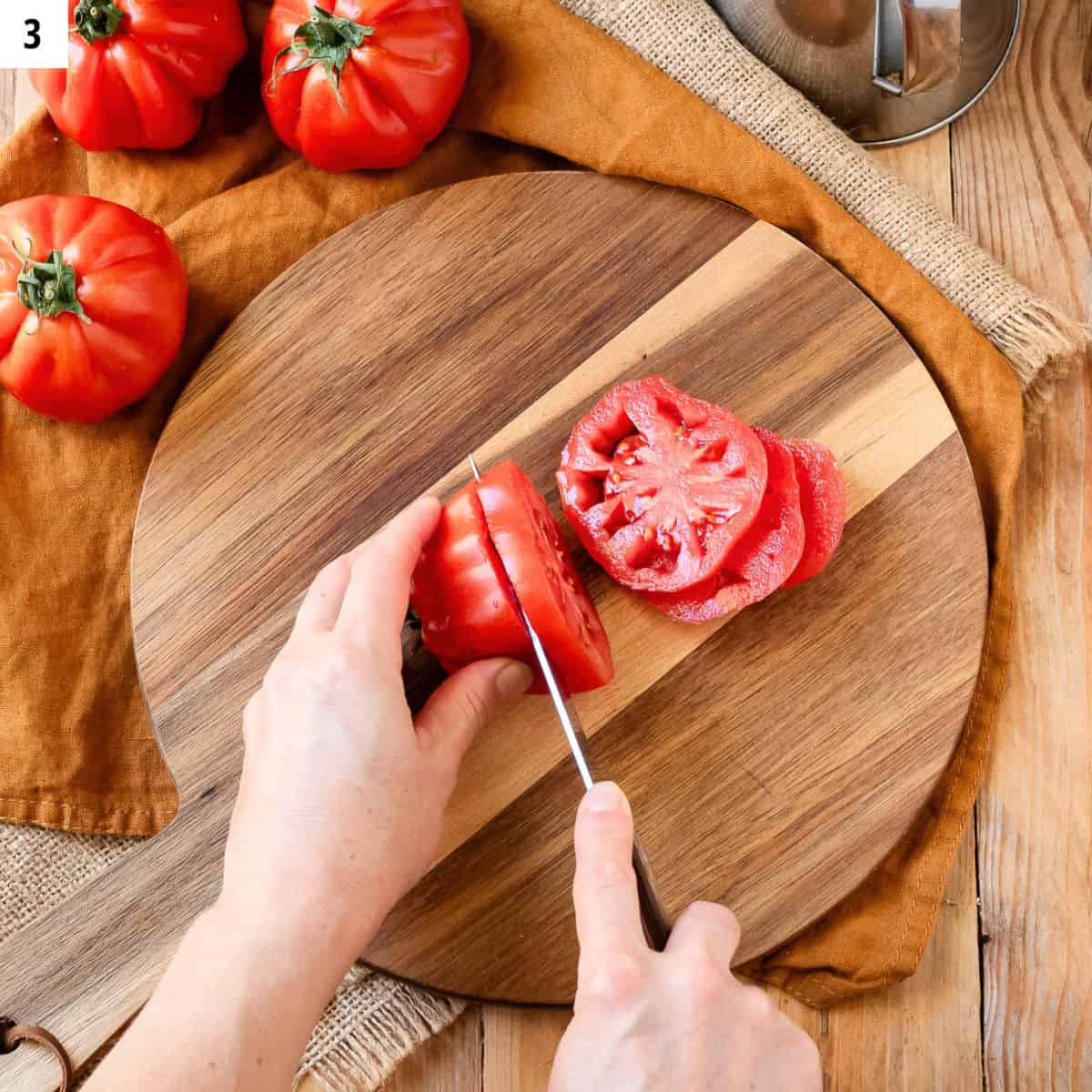 Cutting tomato into slices.