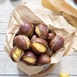 Roasted chestnuts in a paper bag.