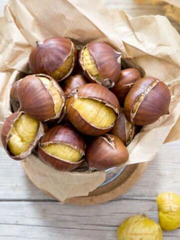 Oven roasted chestnuts in a paper bag.