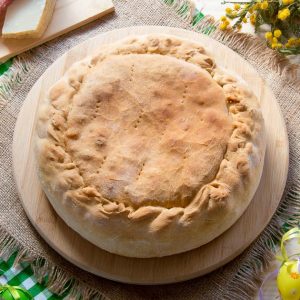 Whole Pizza Rustica on a serving plate