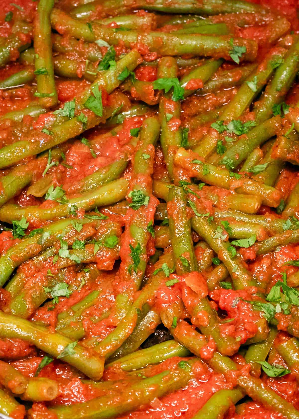 Green beans and tomatoes topped with parsley.