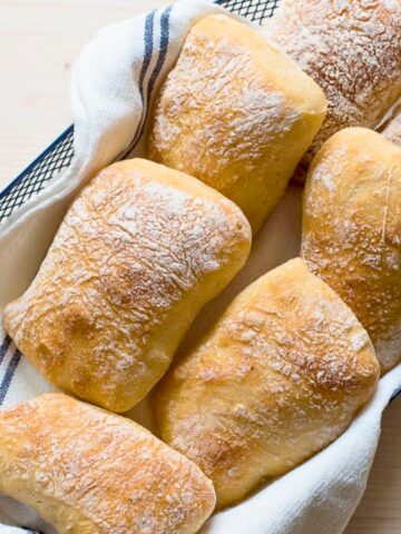 Italian ciabatta rolls in a basket.