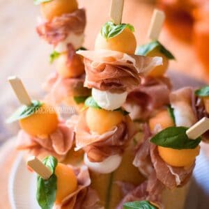 Melon and prosciutto skewers, close up view.