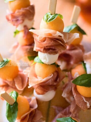 Melon and prosciutto skewers, close up view.