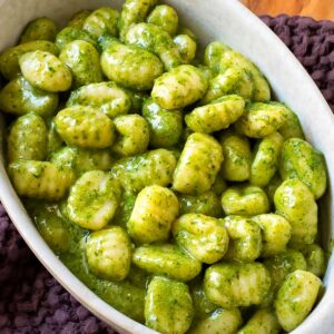 Gnocchi al pesto, super creamy, close up view.