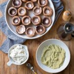 mushrooms, seasoned ricotta, breadcrumbs and olive oil on a wooden board