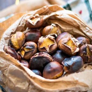 Roasted chestnuts in a paper bag.