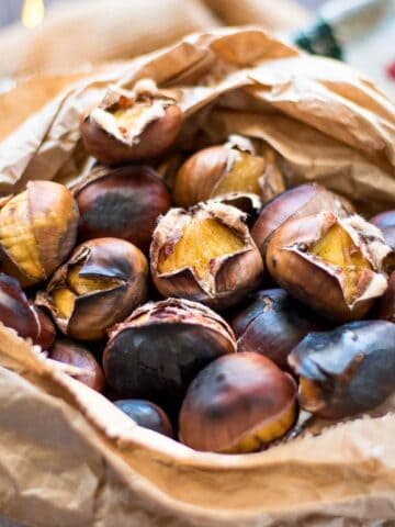 Roasted chestnuts in a paper bag.