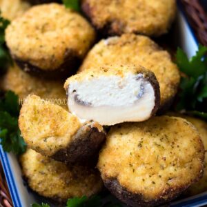 Baked ricotta stuffed mushroom in a serving dish.