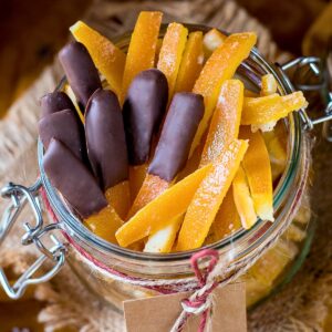 Candied orange peels in a glass jar.