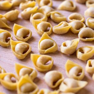 handmade tortellini on a wooden board