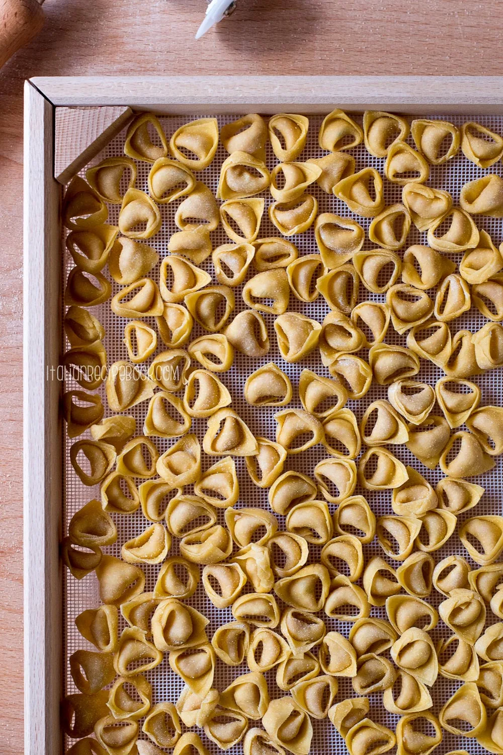 Making Pasta and Tortellini at Home on Wooden Rack and Chrome Pasta Maker  Stock Photo - Alamy