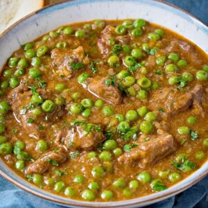 Spezzatino beed stew with peas in a bowl.