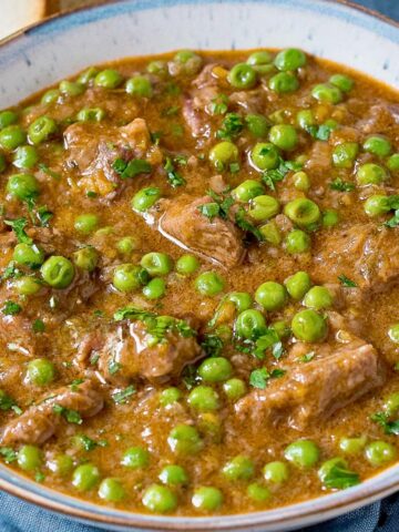 Spezzatino beed stew with peas in a bowl.