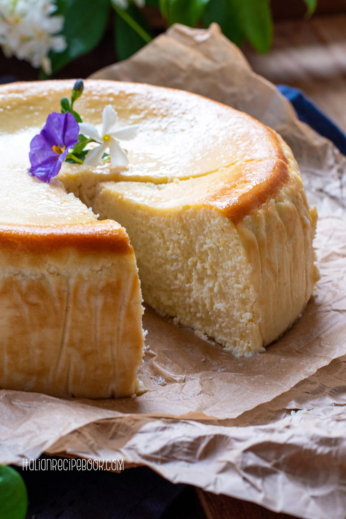 lemon ricotta cheesecake with a cut out piece