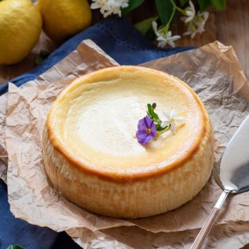 lemon ricotta cheesecake with a cake spatula on the side