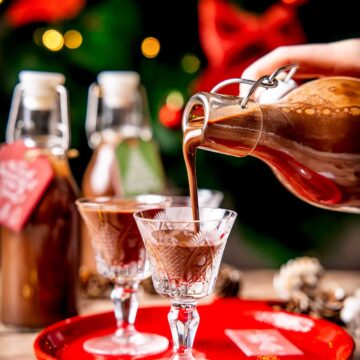 Pouring chocolate liqueur in a liqueur glass.