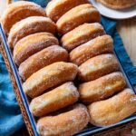 Graffe - Italian potato doughnuts on a tray.