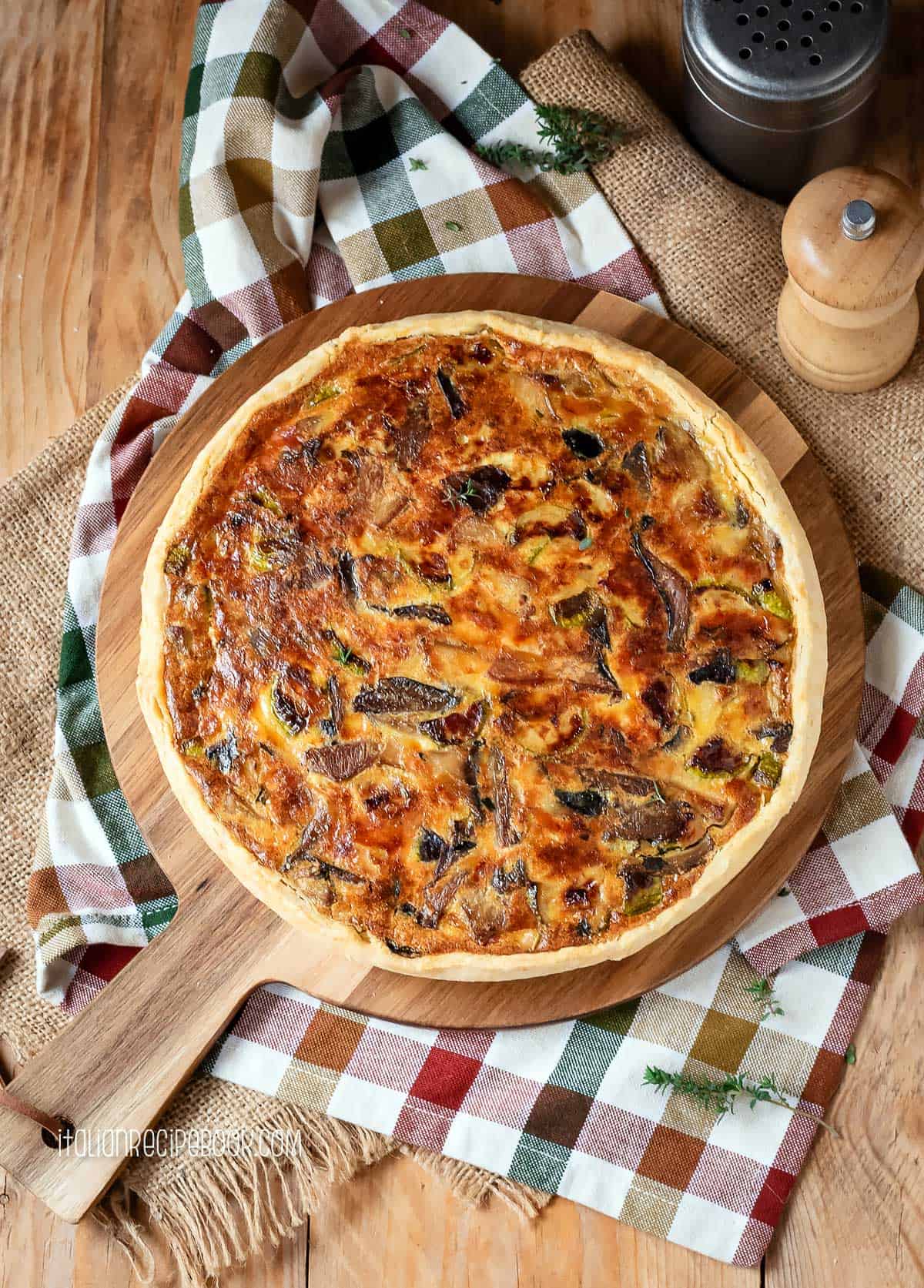 Torta salata on a wooden board, overhead view.