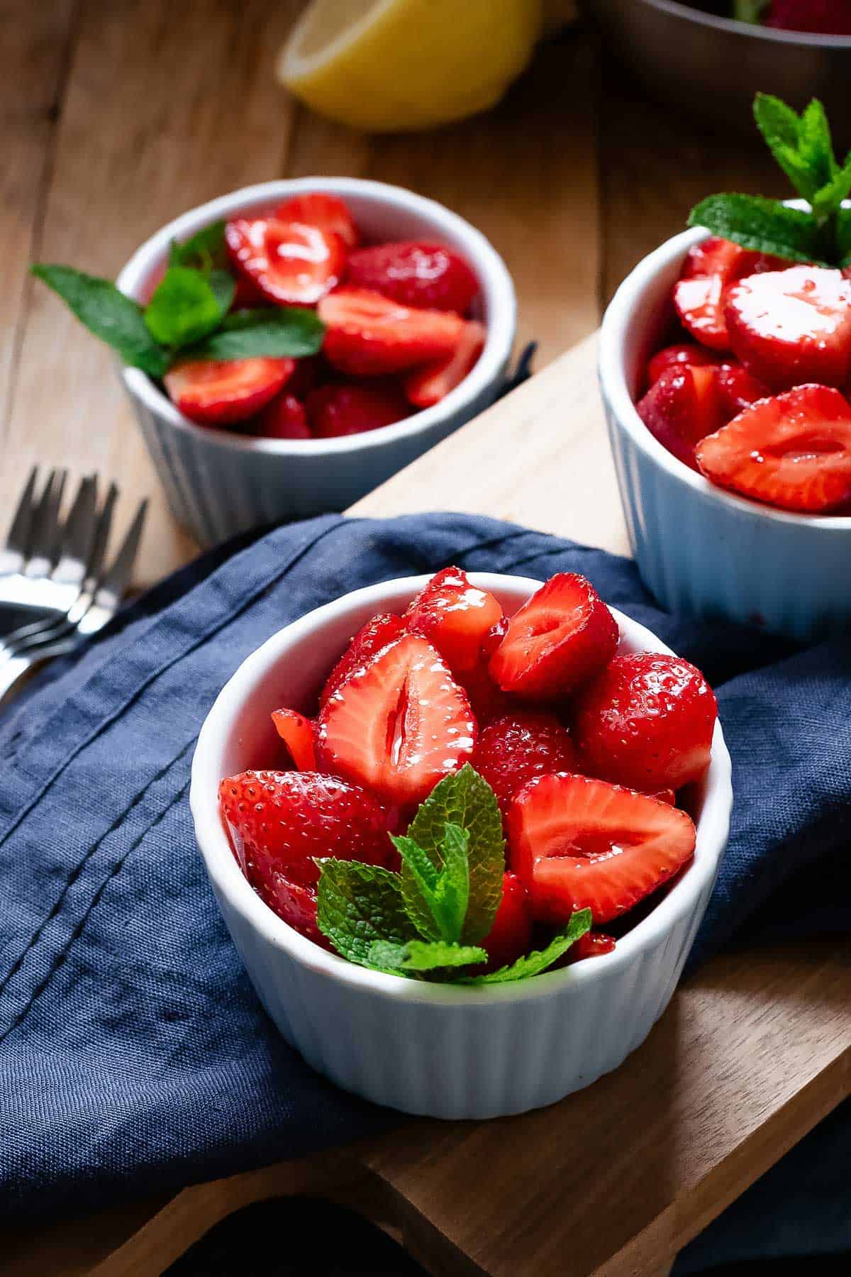 Macerated strawberries in serving bowls.