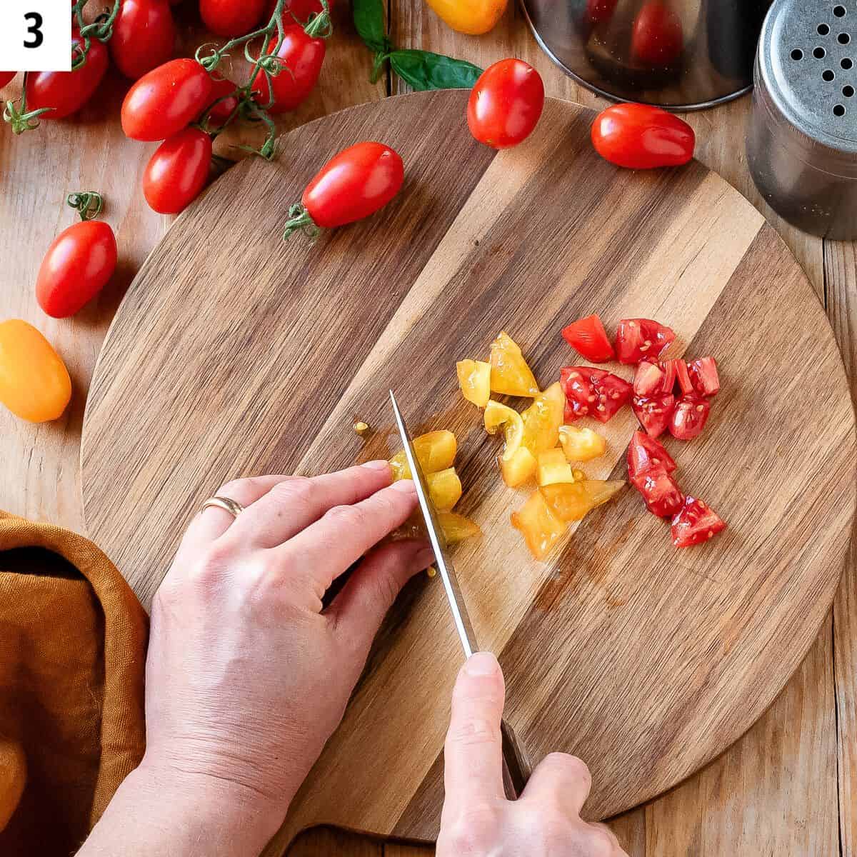 Cutting cherry tomatoes into fine cubes.