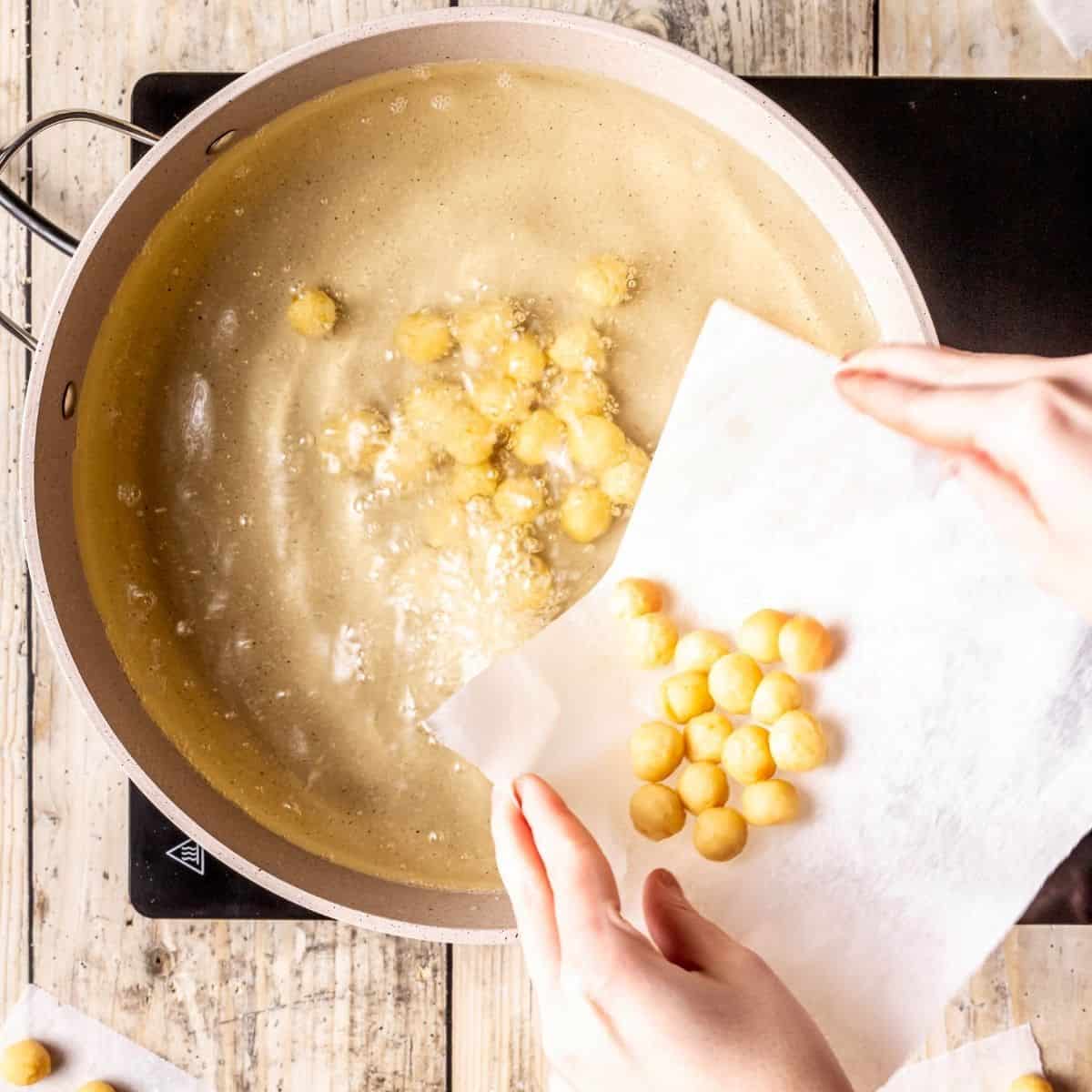 Frying struffoli in hot oil.