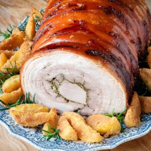 Porchetta pork roast on a serving dish.