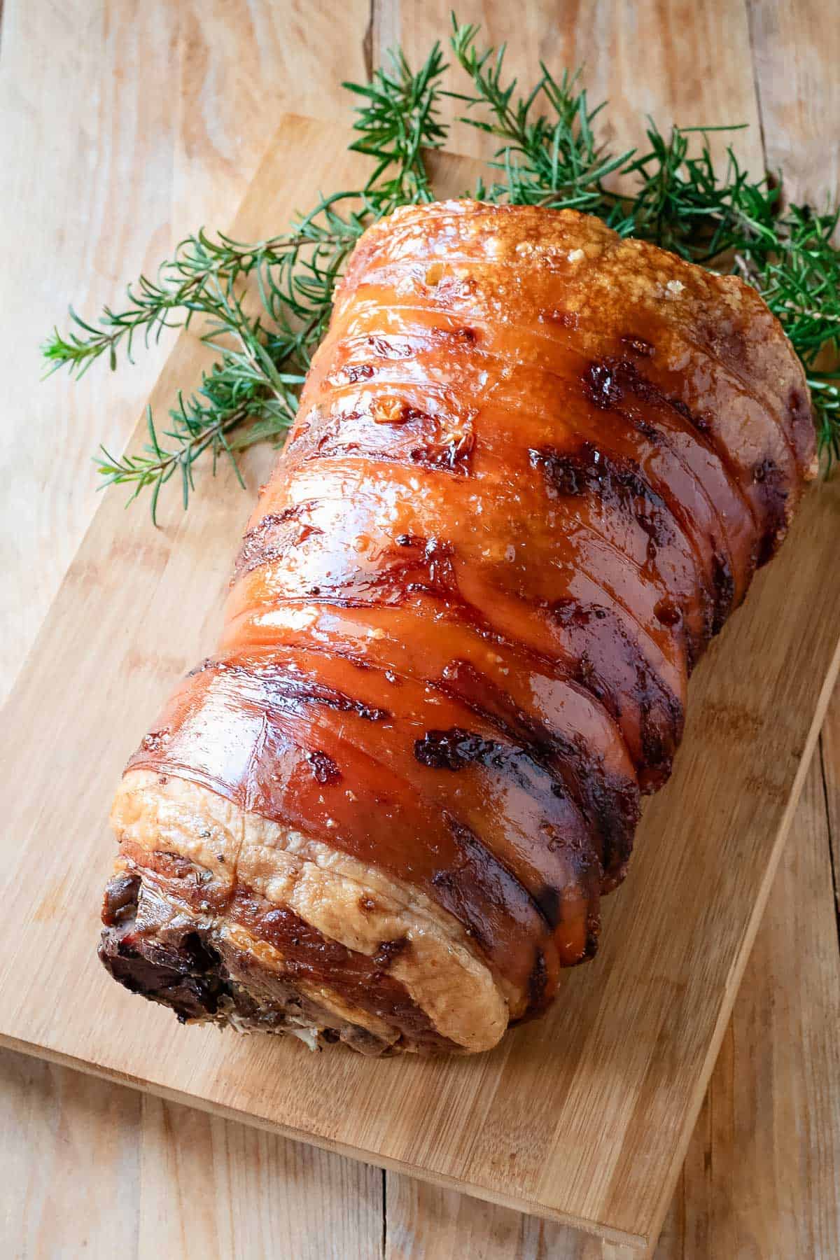 Porchetta on a woodenn cutting board.