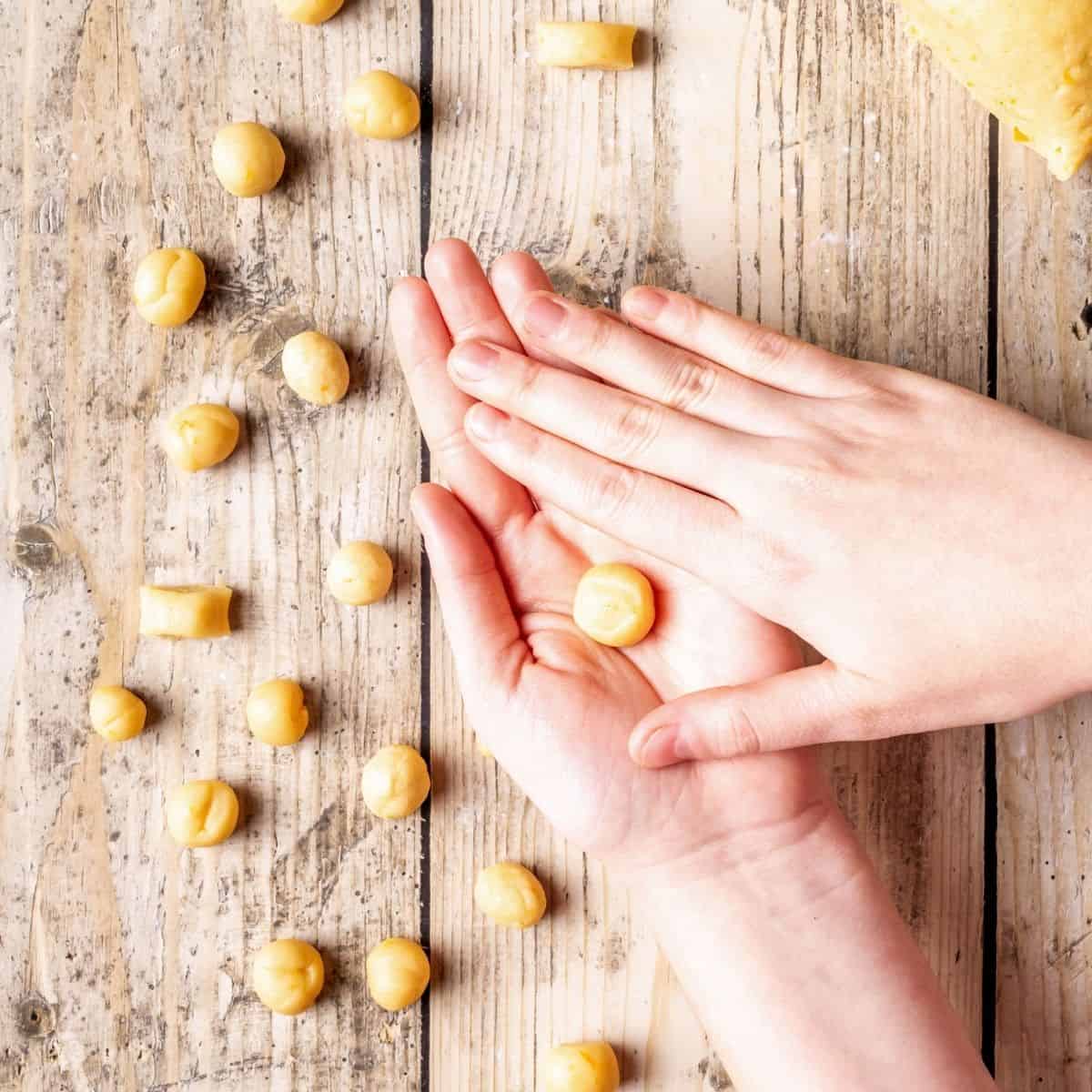 Rolling dough balls between the palms.