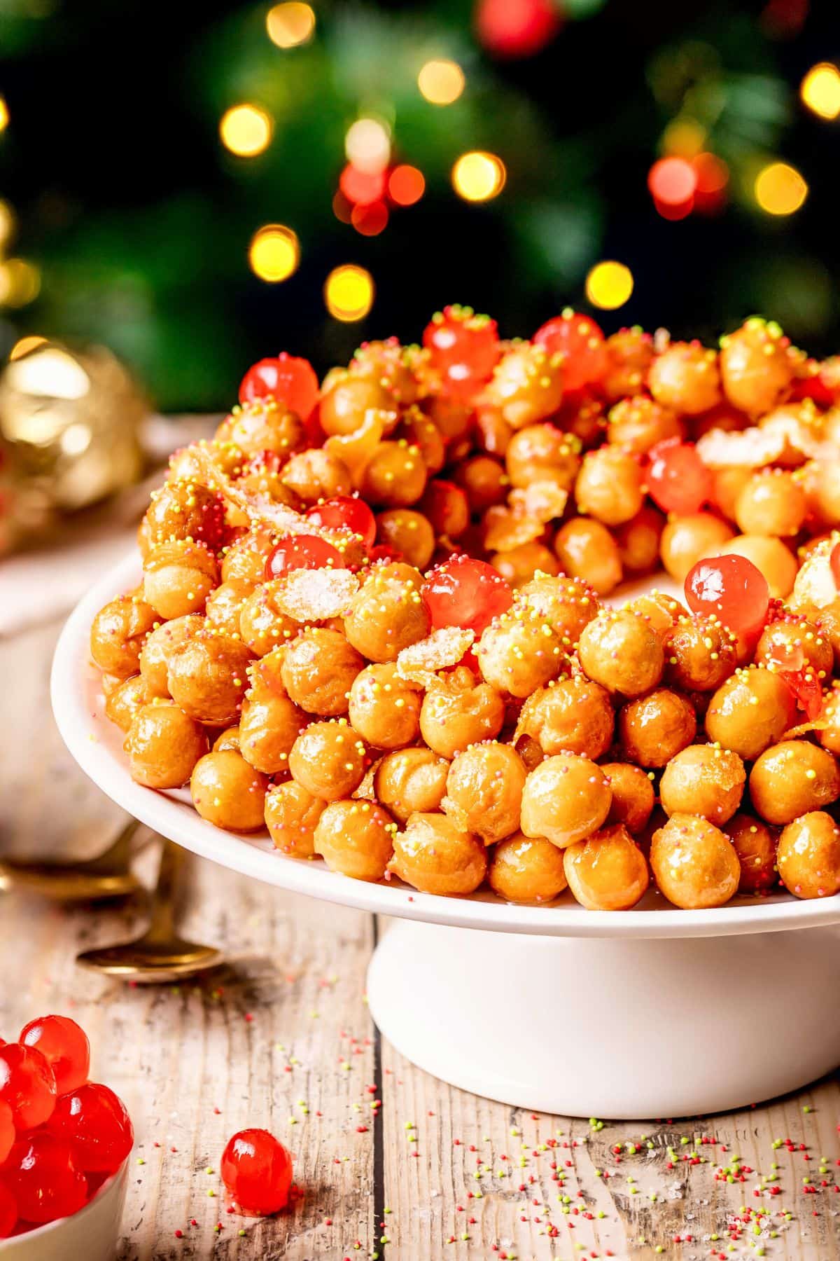 Struffoli honey balls decorated with candied cherries.