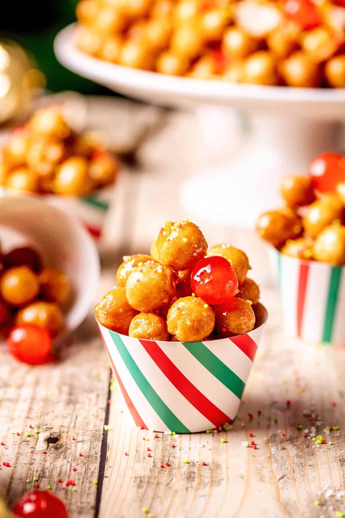 Struffoli in an individual paper cup.