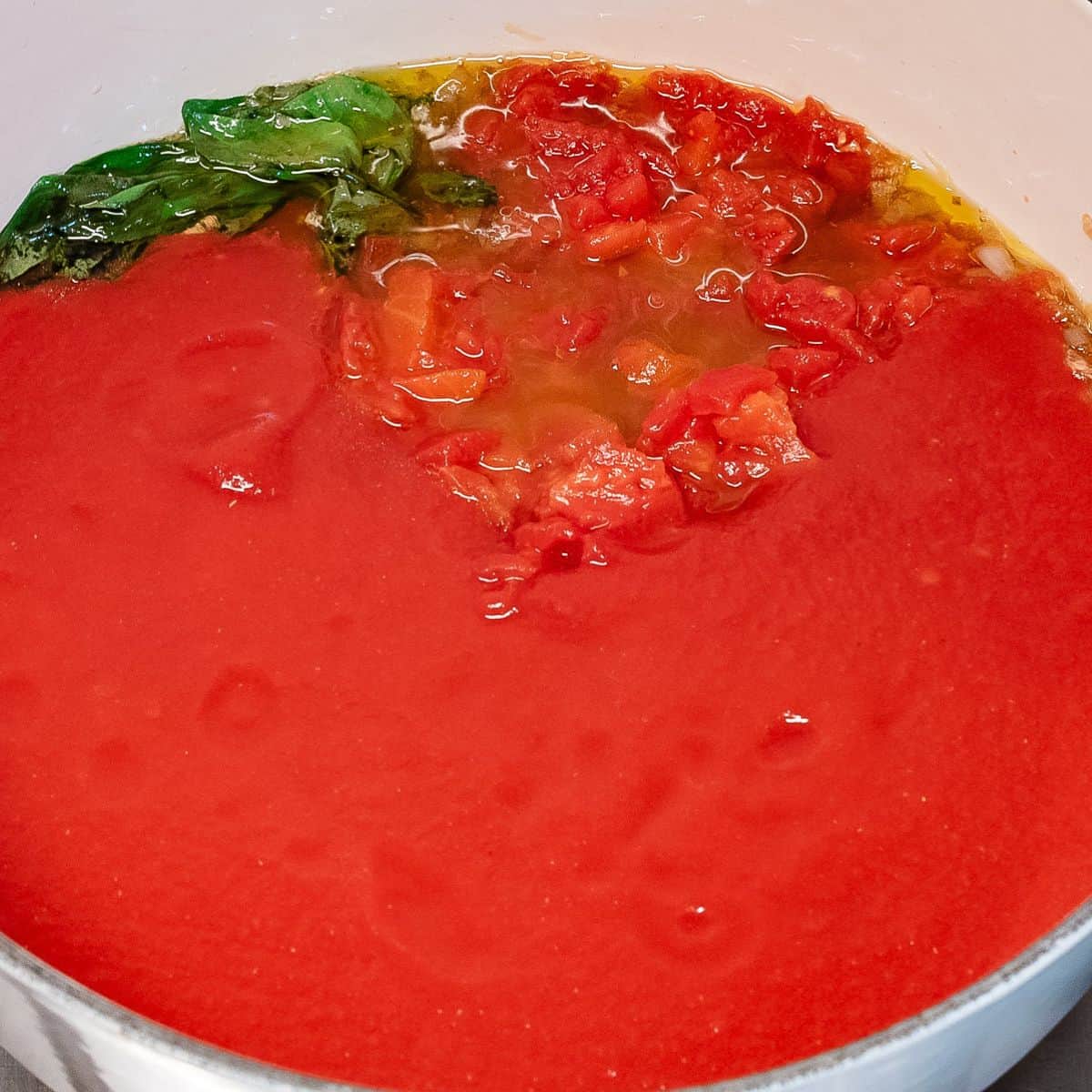 Adding tomato passata.