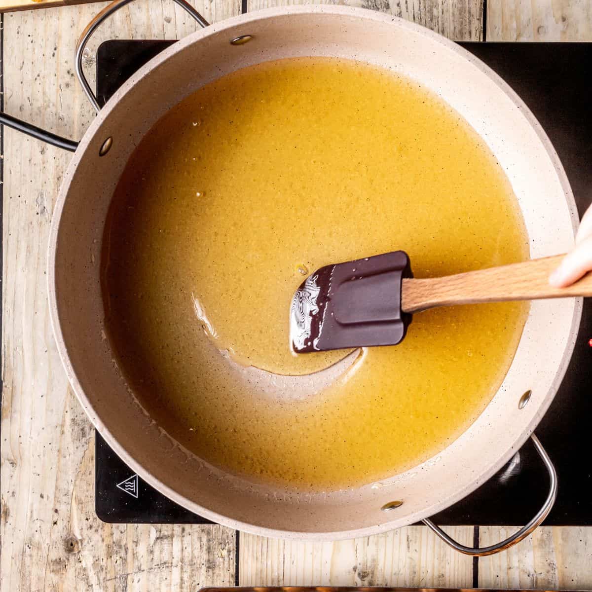 Warming honey in a pan.