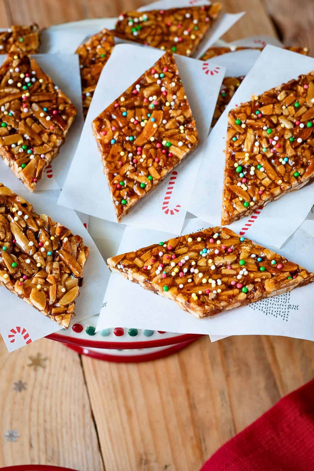 Almond brittle slices on a dessert tray.