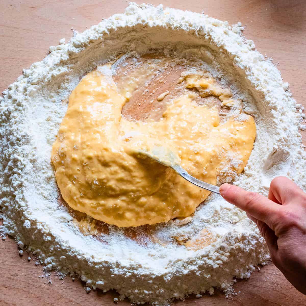 Egg mixture with flour getting thicker.