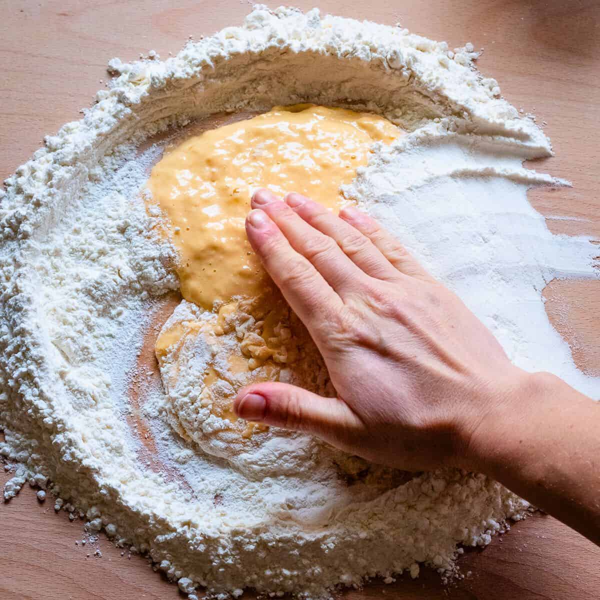 Covering egg mix with the remaining flour.