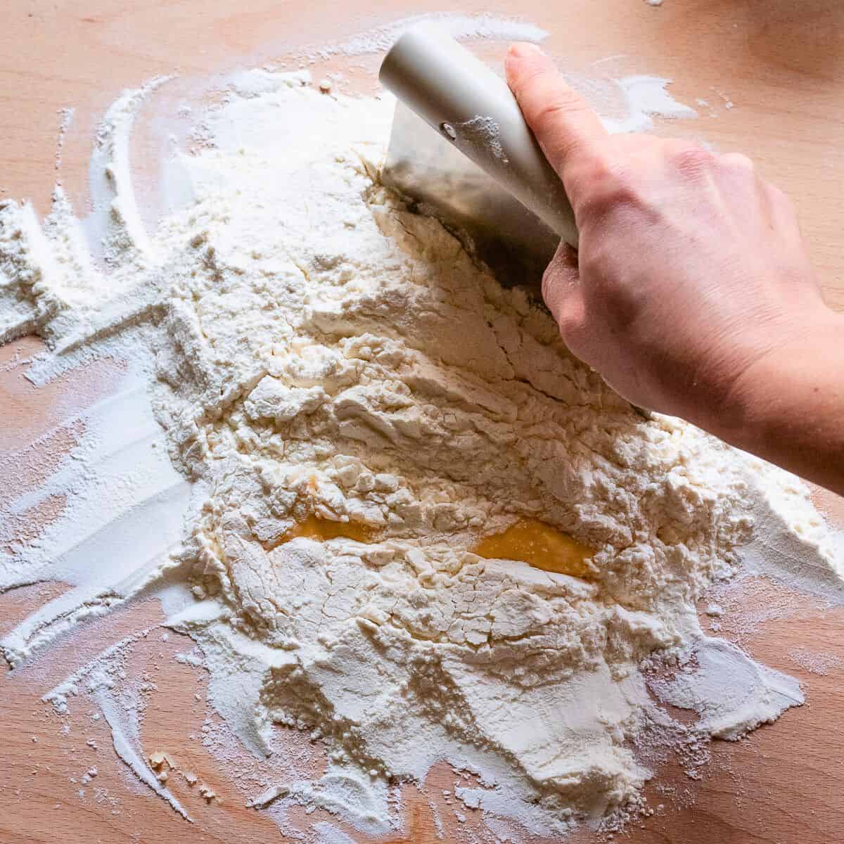 Chopping flour into egg mixture.