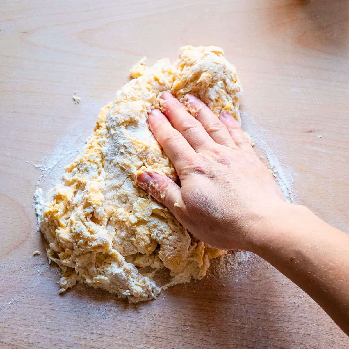 Kneading egg dough with hands.