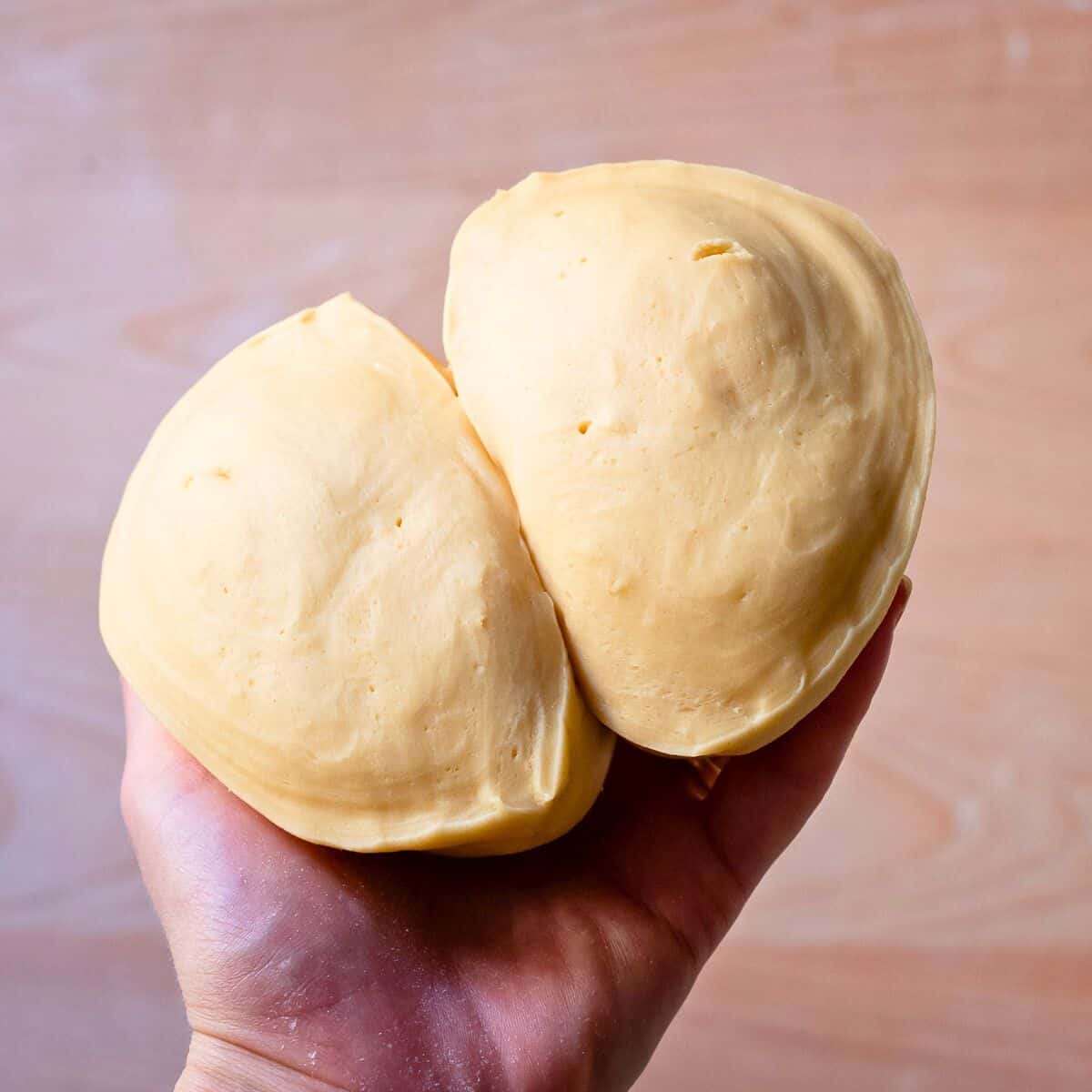 Pasta dough cut in half, showing its characteristic air bubbles.